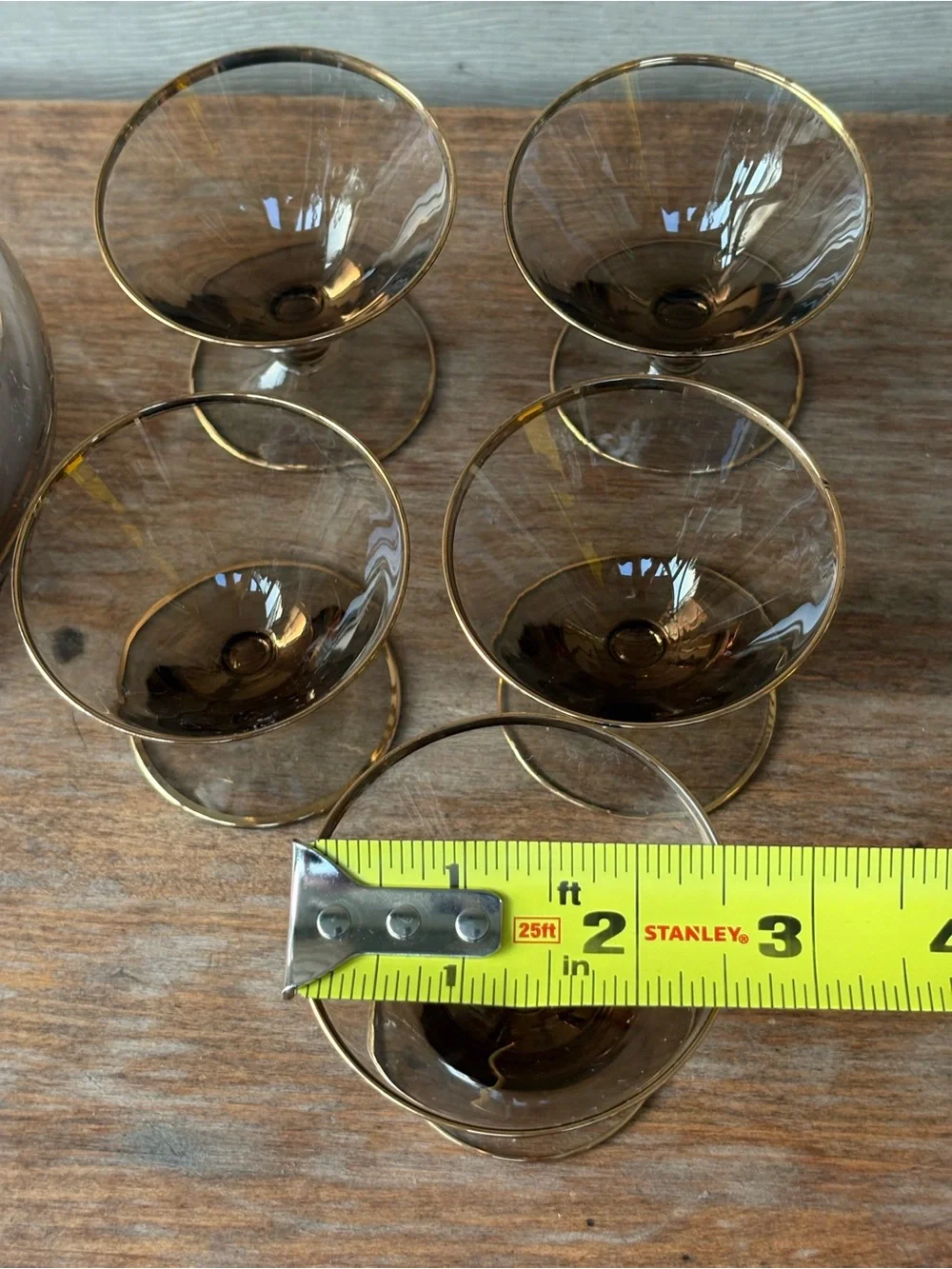 Art Deco decanter set features smoky purple glass adorned with a gold floral